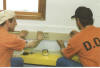Inmates prepare a classroom for high speed internet access.